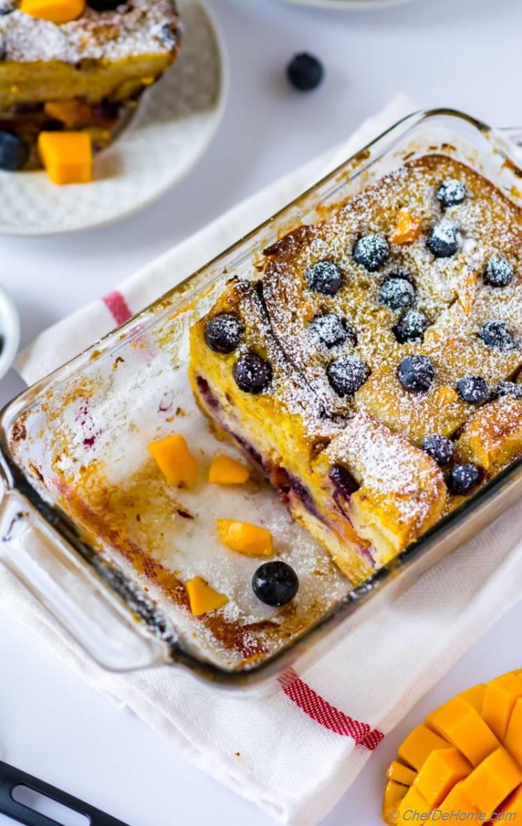 Juicy mango fresh blueberries in a comforting bread-pudding breakfast