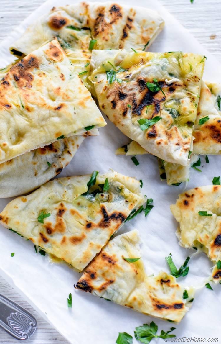Hand Rolled Cheese stuffed Homemade Indian Garlic Naan to dunk in hot Creamy Soup | chefdehome.com