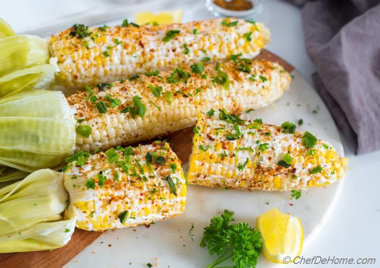 Corn on the cob with sour cream and cajon seasoning