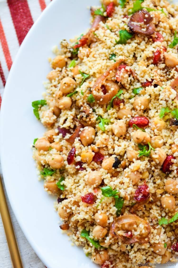 Couscous Tfaya, warm, spiced, and lemony couscous with sweet caramelized onions, cranberries, and chickpeas.