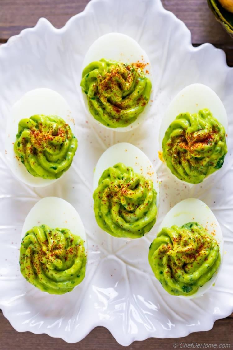 Platter of healthy and paleo deviled eggs for Easter brunch or spring parties. Also kids friendly with mild spicy with creamy taste of avocado