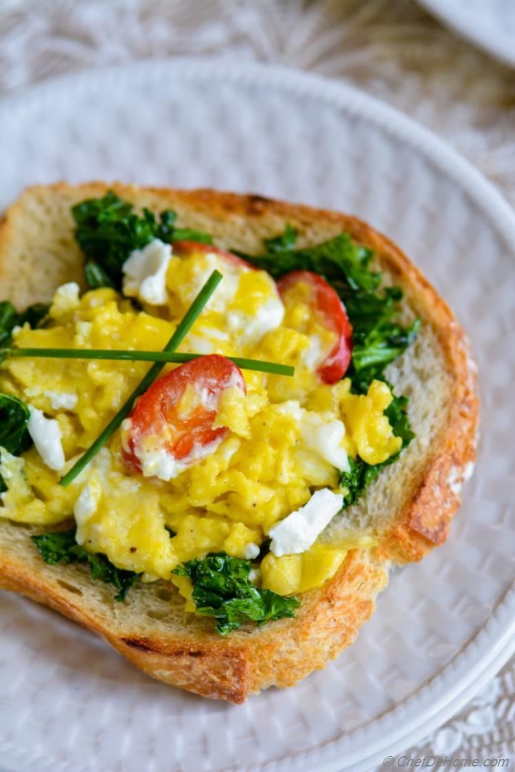 Scrambled Eggs with Goat Cheese and Kale on a garlic toast for delicious and hearty breakfast | chefdehome.com