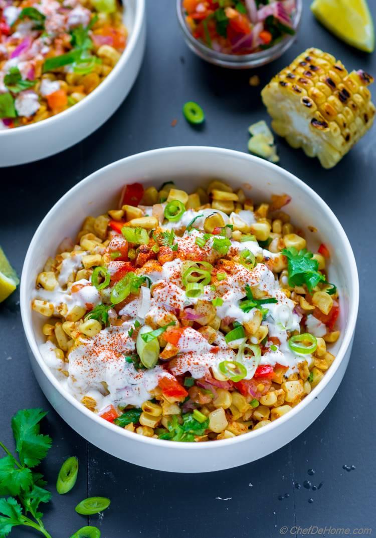 Esquites - a Mexican corn salad with spices salsa and sour cream