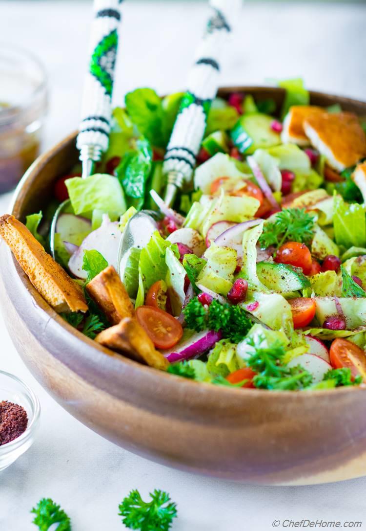 Bowl of Fattoush Salad with lettuce, cucumber, tomatoes, mint  and sumac dressing