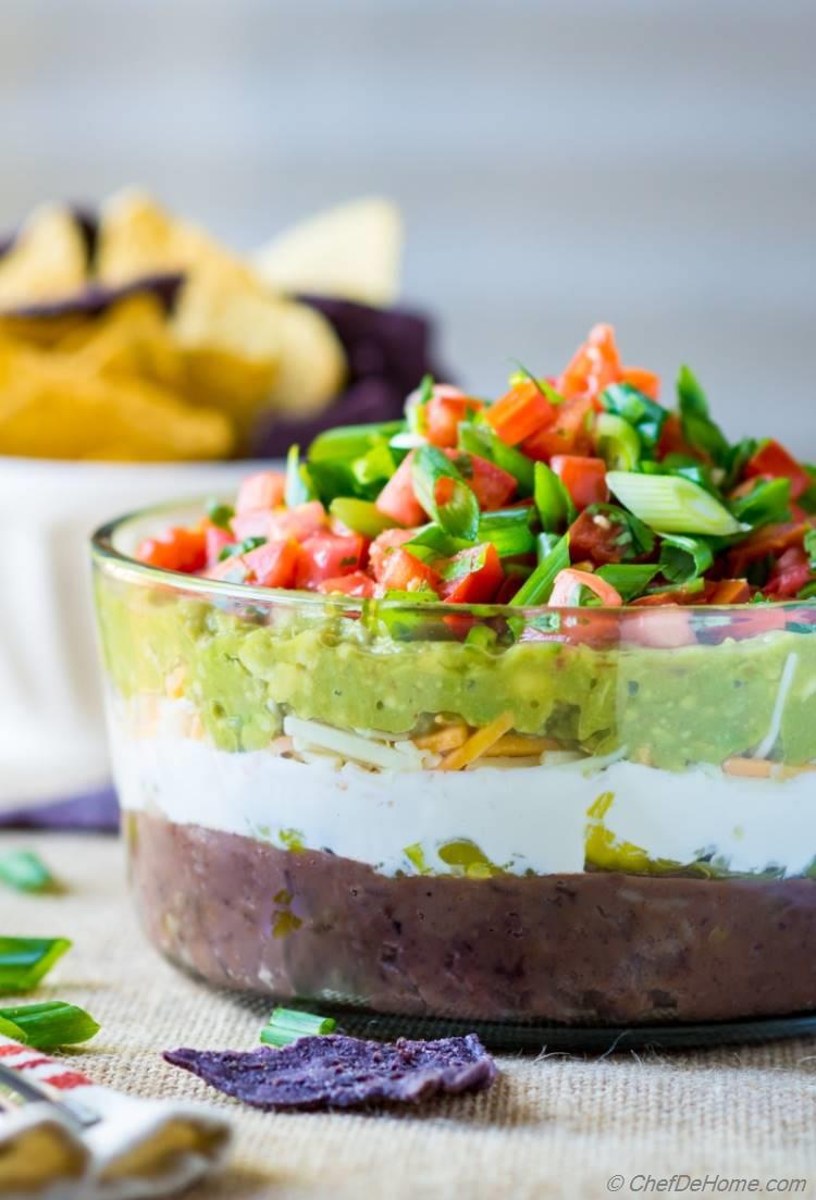 Easy game day appetizer of 7 Layer Mexican Dip with fresh guacamole refried beans and sour cream | chefdehome.com
