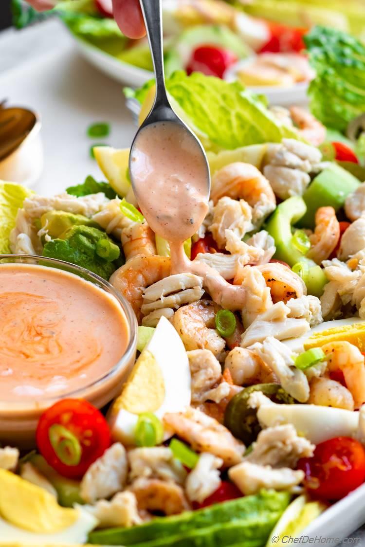 Crab Louie Salad Dressing drizzled on Louie Salad