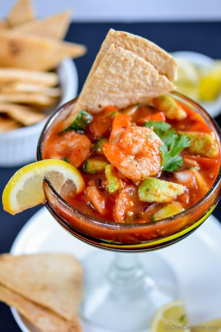 Mexican Shrimp Cocktail loaded with fresh avocado cucumber tomatoes shrimp and zesty bloody mary sauce | chefdehome.com