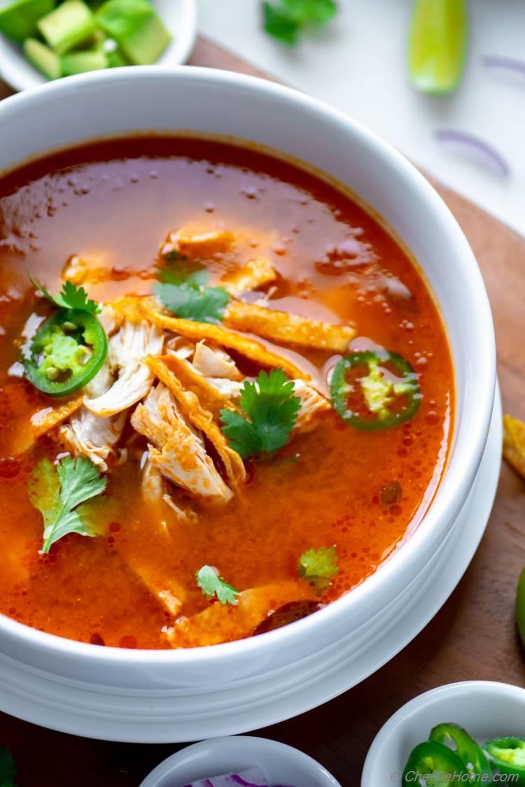 Bowl of Chicken Tortilla Soup with Tortilla Strips and Chicken Breast