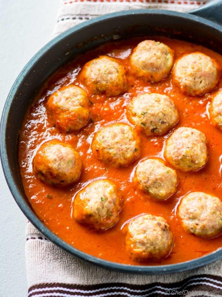 Turkey meatball simmering in marinara sauce | chefdehome.com